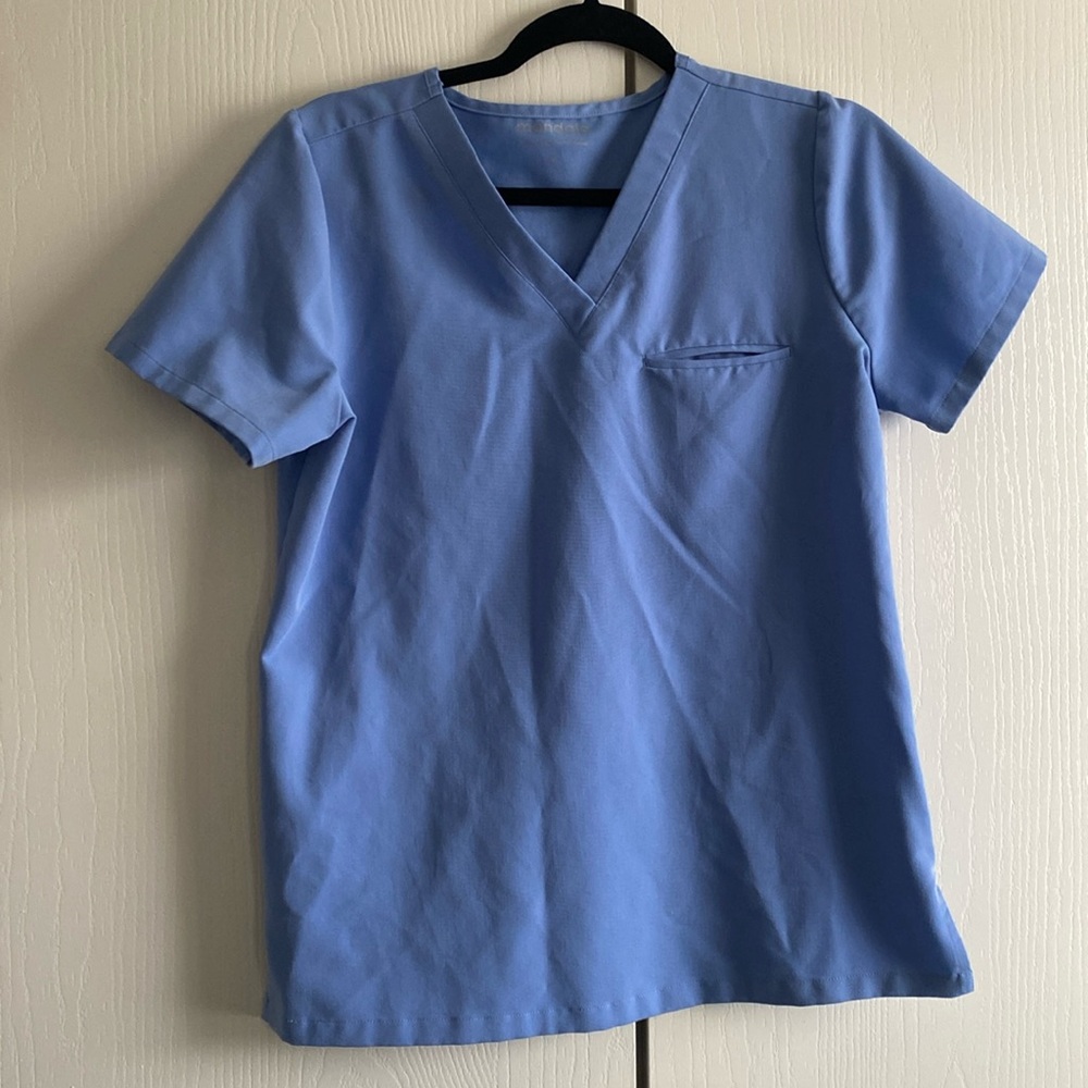 This is a Mandala scrub top with one pocket. Size small, color is coastline blue